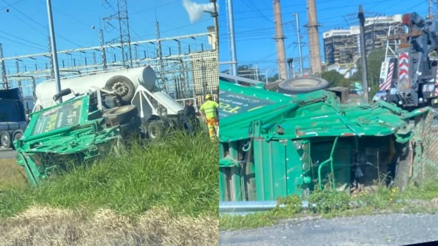 Caminhão de lixo tomba na marginal da BR-101 em Capivari de Baixo